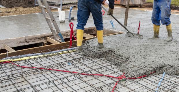 Männer legen Fundament für Hausbau - Blitzschutz und Erdung anschaulich